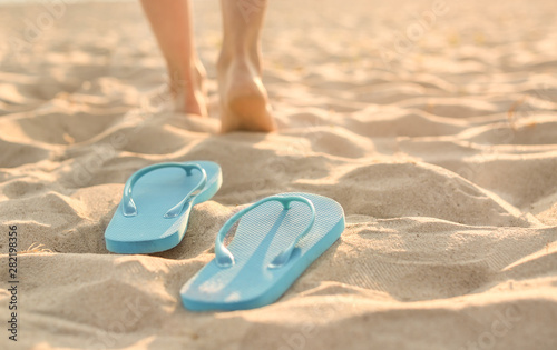 Flip-flops on sand beach at resort