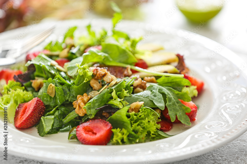 Plate with fresh tasty salad on table, closeup Plate with fresh tasty salad on table, closeup