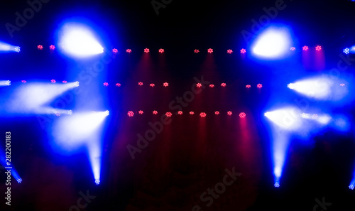 Beautiful concert light on an empty stage in the smoke. Disco and laser show.