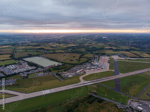 Aerial photo of the famous Leeds and Bradford airport located in the Yeadon area of West Yorkshire in the UK, typical British airport showing the runway and houses and roads around the airport photo
