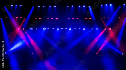 Beautiful concert light on an empty stage in the smoke. Disco and laser show.