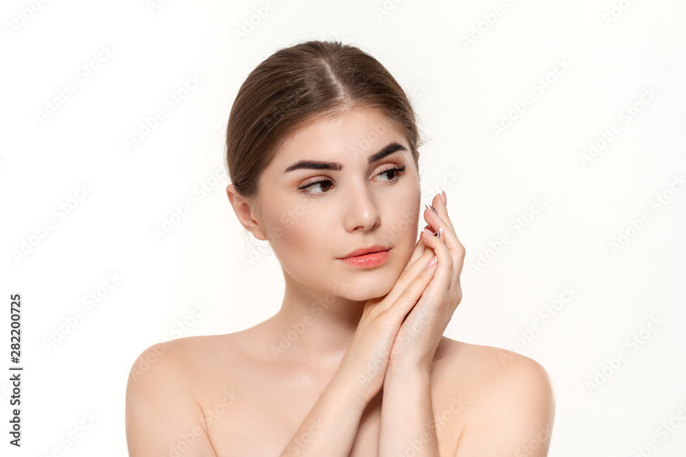 Close-up portrait of a beautiful young girl with holding hands near face isolated over white background. Close-up portrait of a beautiful young girl with holding hands near face isolated over white background.
