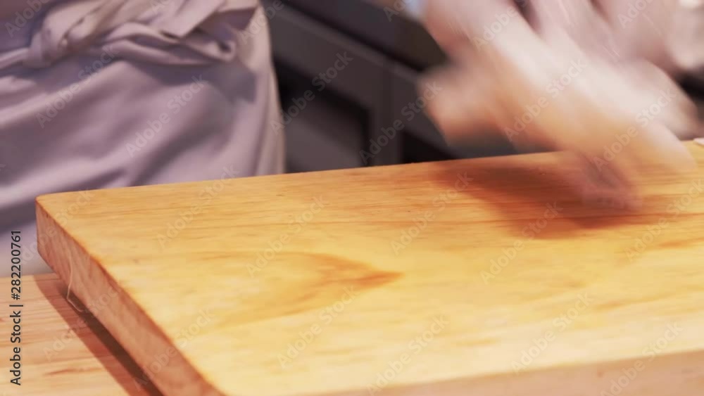 Japanese cuisine. A chef slicing tuna fillet for sushi producing. Japanese cuisine. A chef slicing tuna fillet for sushi producing.