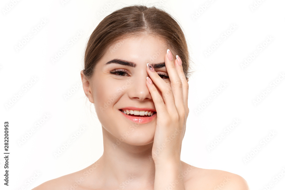 Close-up portrait of a beautiful young girl with holding hands near face isolated over white background.