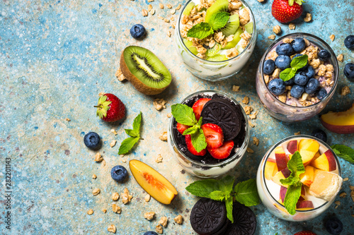 Fruit Dessert in glasses with yogurt and berries.