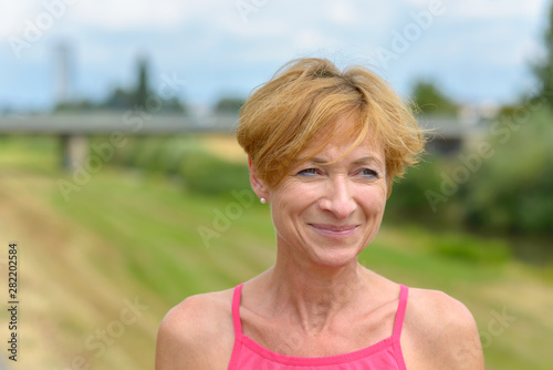 Happy woman smiling to herself as she watches