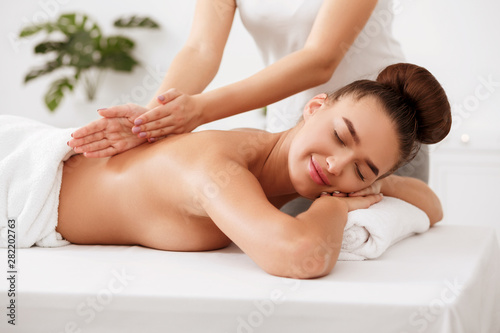 Body care. Relaxed woman enjoying back massage