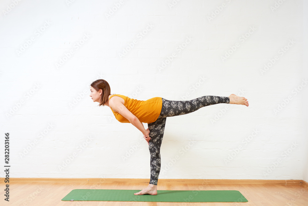 Healthy woman doing yoga exercise, stretching