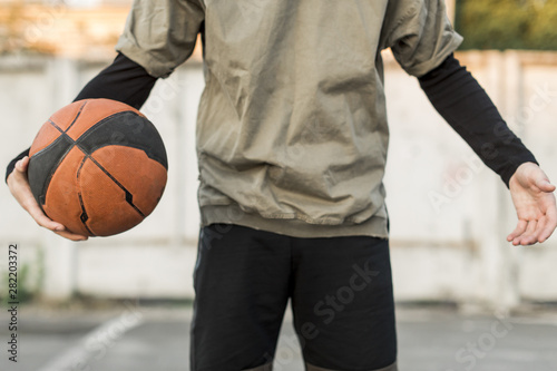 Front view man holding a basketball