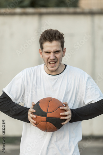 Front view man holding a basketball