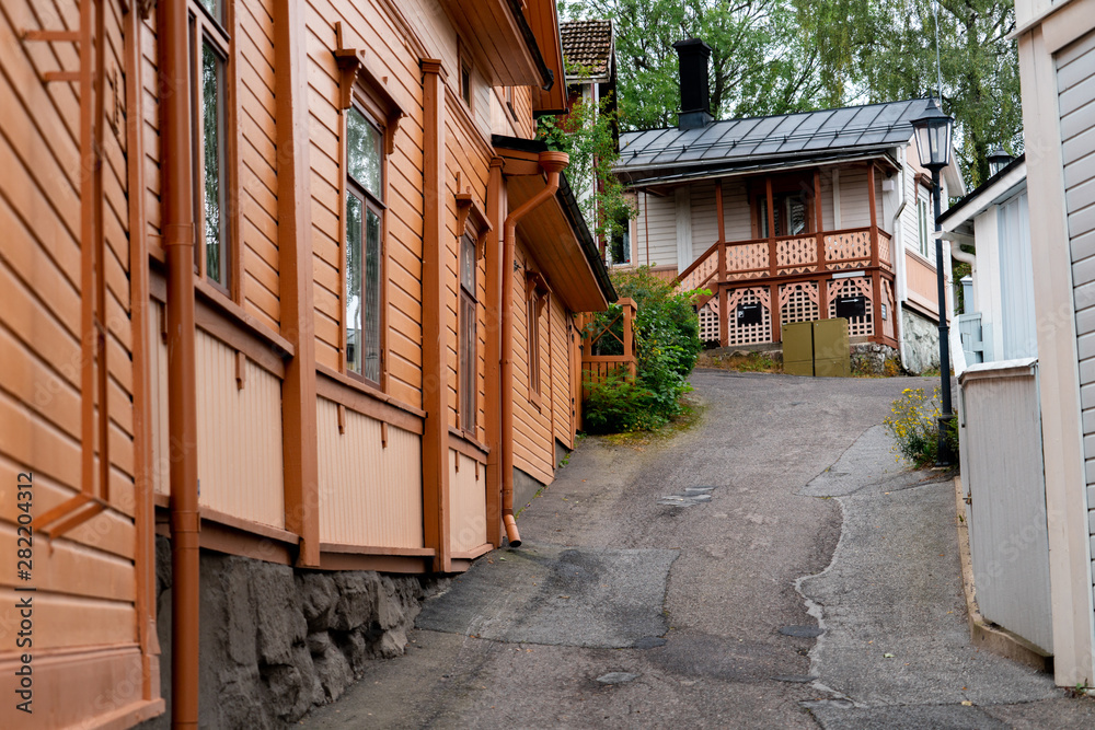 Street of Scandinavian city with traditional wooden houses. Street of Scandinavian city with traditional wooden houses.