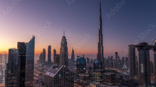 Dubai downtown skyline with tallest skyscrapers and busiest traffic on highway intersection night to day timelapse © neiezhmakov