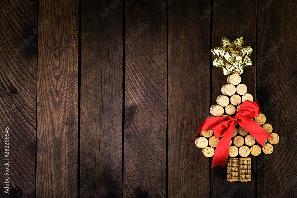 Christmas tree made of wine corks on wooden background. Mockup postcard with Christmas tree and copy space for text. Top view.