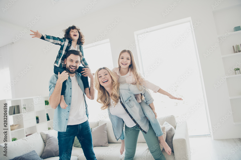 Photo of big family four members having best free time hands like wings airplane flight indoors apartments - obrazy, fototapety, plakaty 
