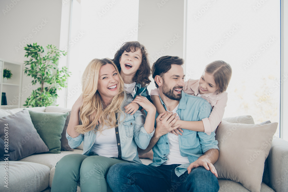 Photo of four family members spend time rejoicing giggle piggy back position sit couch living room