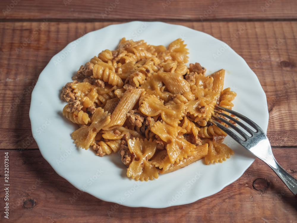 Dark flour paste with Turkey minced meat on a white round plate