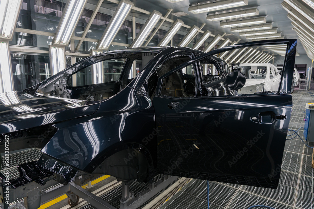 Close-up of the car body after painting at the car factory. Machine Assembly production