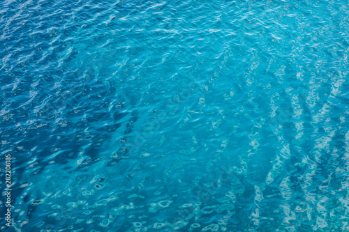 Blue sea surface with transparent shallow water