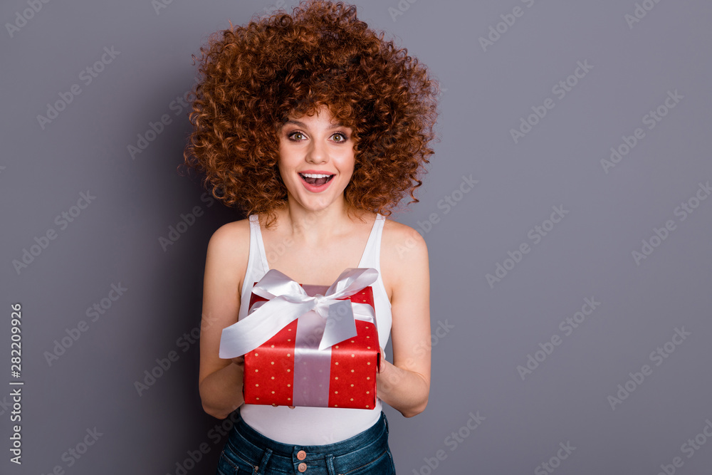 Close up photo of volume hairdo pretty lady giving big giftbox best guest wear white tank-top isolated grey background Close up photo of volume hairdo pretty lady giving big giftbox best guest wear white tank-top isolated grey background