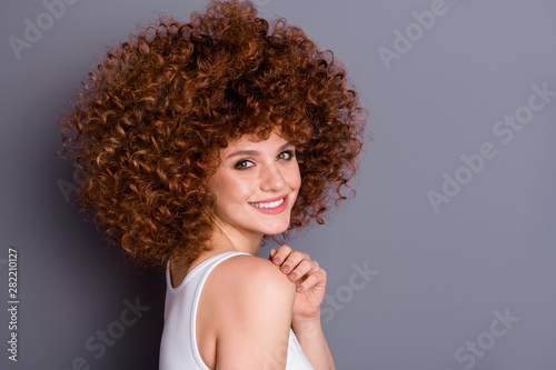 Profile photo of curly hairdo lady natural hair color perming against wig concept wear white tank-top isolated grey background