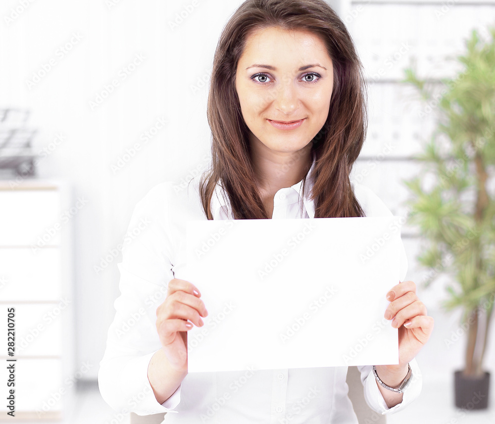 business woman showing blank sheet,sitting behind a Desk business woman showing blank sheet,sitting behind a Desk