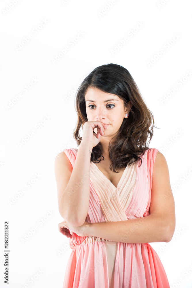 Isolated young woman on a pink dress while on deep thought Isolated young woman on a pink dress while on deep thought
