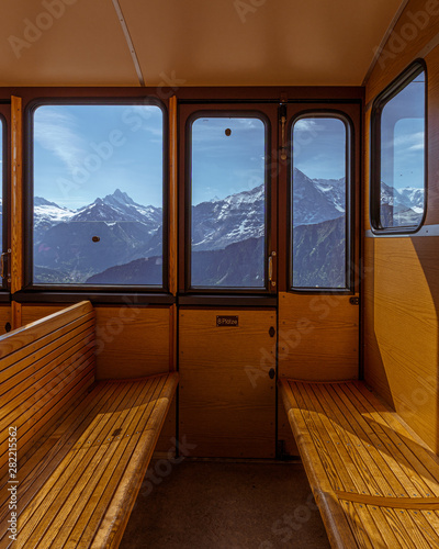 Inside view of a train with mountains in the background