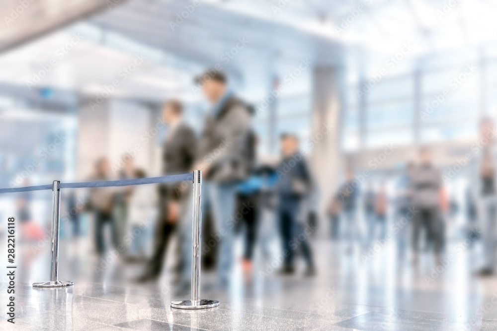Obraz premium airport interior of modern terminal building arriving exit passage blur background wide inside view of business air travel trip blurred design concept with people waiting for passengers in sunny hall