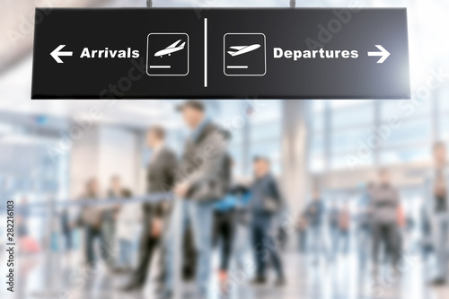 airport interior of modern terminal building blur background with arrivals departures sign wide inside view of business air travel trip design concept with people waiting for passengers in sunny hall