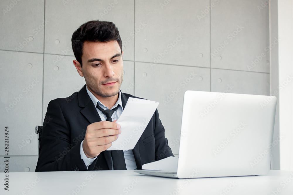 Male employees are holding documents in skepticism. Male employees are holding documents in skepticism.