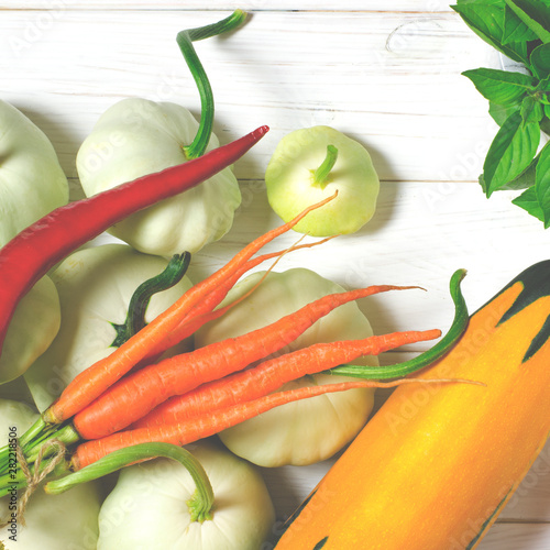 Harvest. Patisons, garlic, carrots, basil, lentils and zucchini lie on a wooden table photo