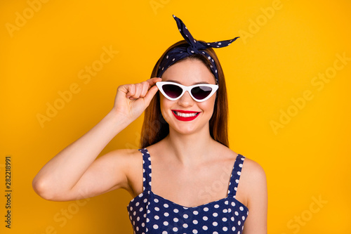 Close-up portrait of her she nice-looking attractive lovely fascinating glamorous pretty cheerful cheery content straight-haired girl touching glasses isolated on bright vivid shine yellow background