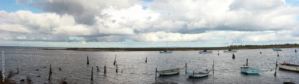 panoramic view of small fishing sail boats tide up in port in an inlet at Werribee south beach, Werribee Victoria