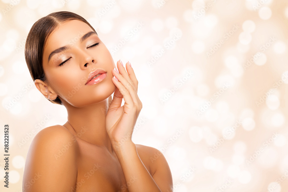 Portrait of young Woman with Perfect Skin touches her Face with her hand. Isolated over peach bokeh background. Eyes closed. Closeup. Natural Makeup. - Image Portrait of young Woman with Perfect Skin touches her Face with her hand. Isolated over peach bokeh background. Eyes closed. Closeup. Natural Makeup. - Image
