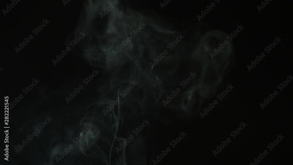 beautiful thick smoke in slow motion, on a black background