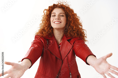 Canvas Print Cheerful lovely dreamy redhead curly-haired woman modern stylish red jacket exte