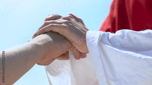 Holy man taking hand of sick, healing from diseases, religious rehab center