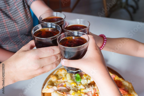 Group of hands with cola close up. The concept of celebration and friendship.