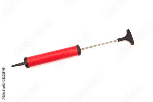 red hand pump for ball on white background.