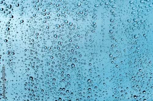 Water drops on glass, green texture