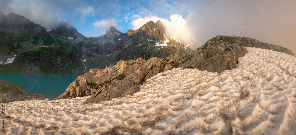 Obraz premium mountainside under snow avalanches with a mountain lake surrounded by mountain peaks, Kluhor, Teberda Nature Reserve