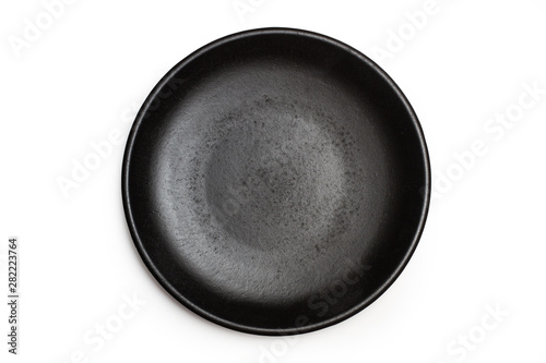 Bild auf Leinwand Plato negro redondo sobre un fondo blanco liso y aislado