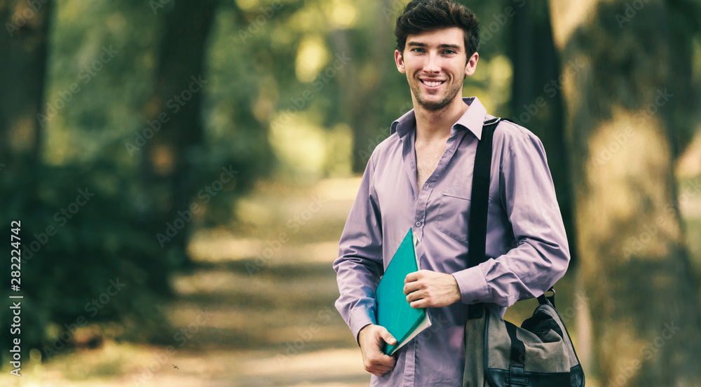 Obraz premium successful student with books in the Park, Sunny day.