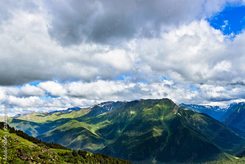 Fototapeta premium caucasian mountains and cloudy sky on a summer day