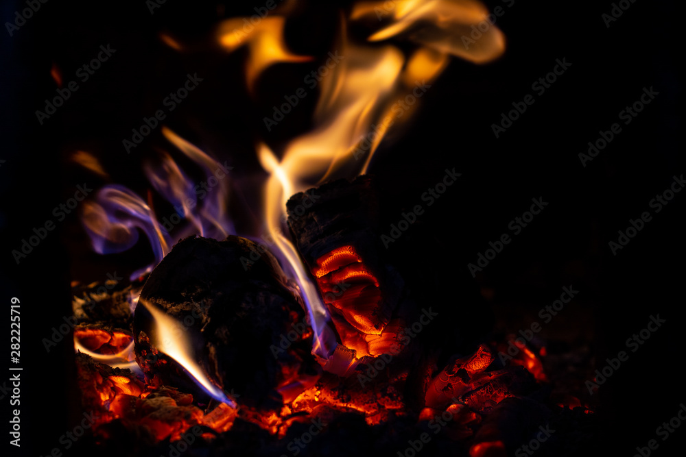 Fototapeta premium Fire is red in a closed oven on black background.