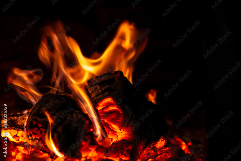Fototapeta premium Fire is red in a closed oven on black background.