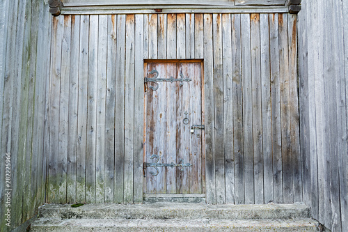 Wooden background. Weathered, ancient wooden door.