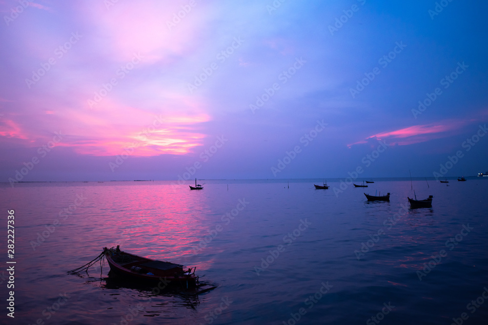local fishing boat in the sea at sunset