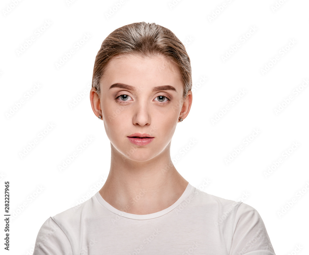 Portrait of attractive serious young girl in white T-shirt Portrait of attractive serious young girl in white T-shirt