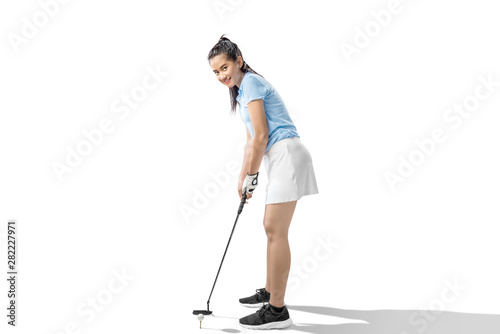 Asian woman with a putter golf club ready to hit the ball